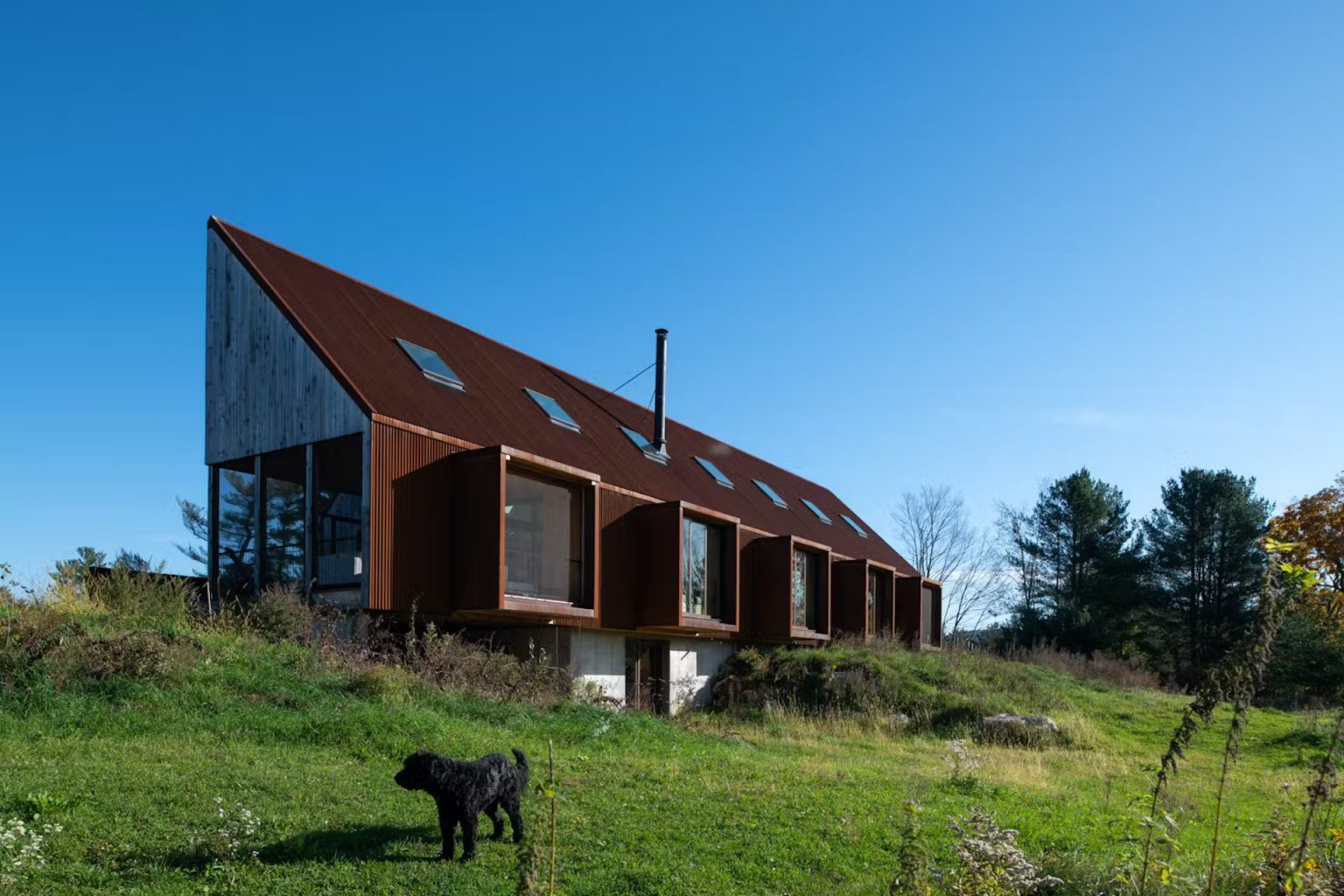 Une maison perchée sur une colline rocheuse inspirée des granges