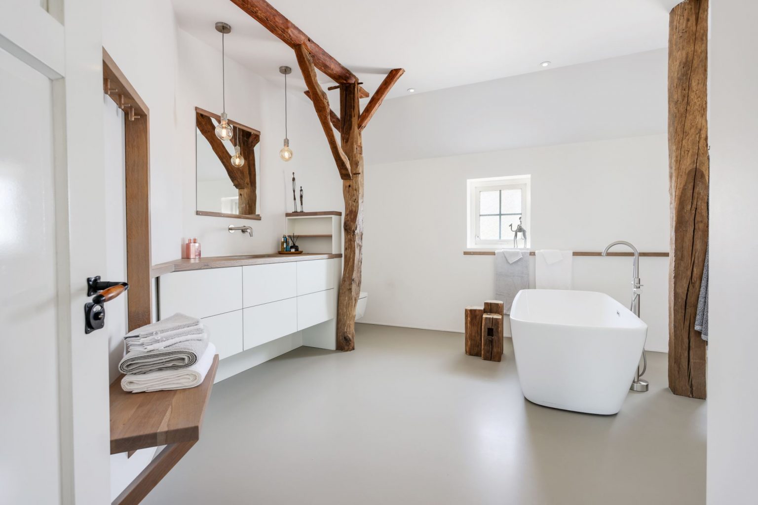 salle de bain design avec poutres maison rénovée