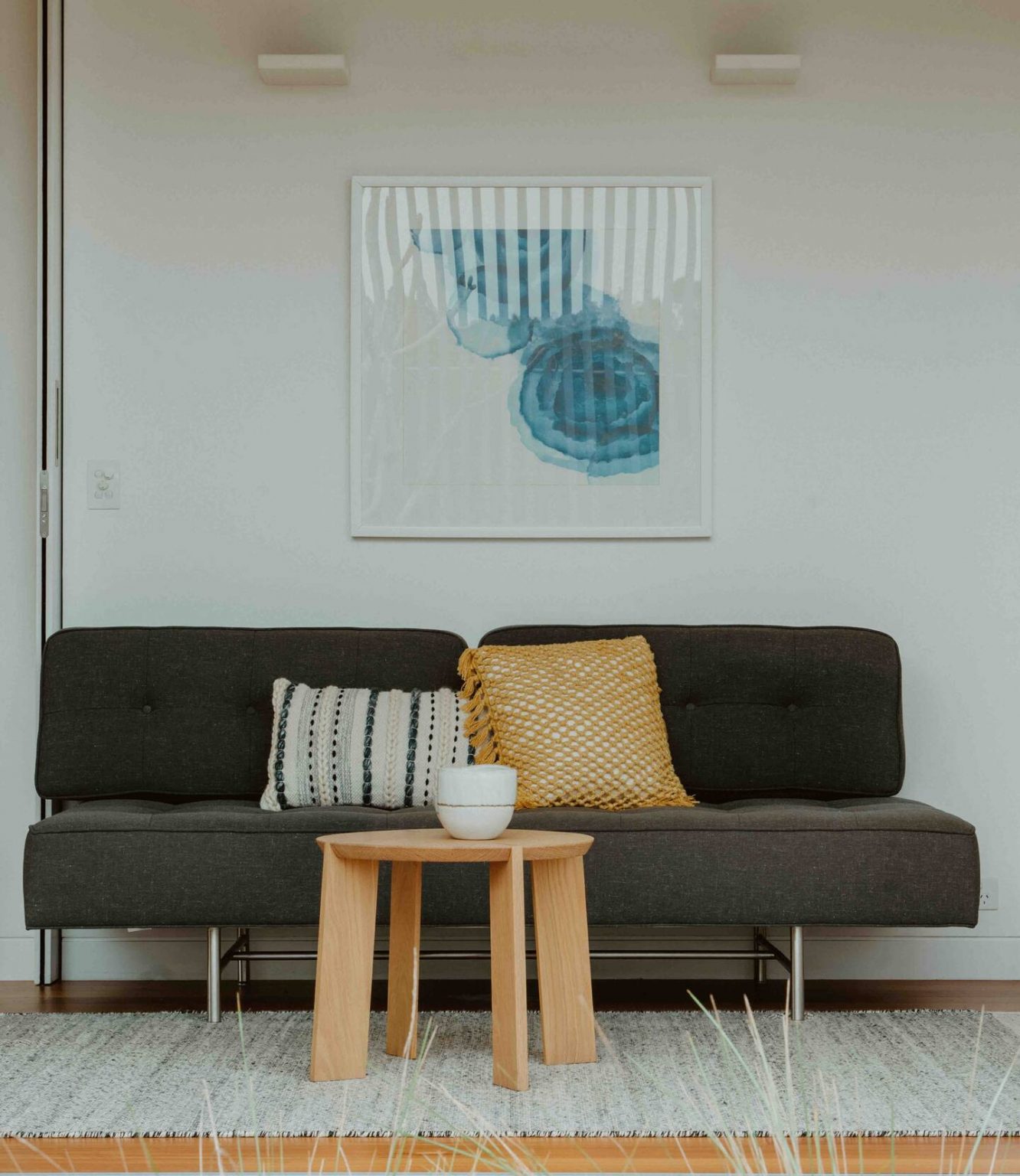 Living room with small designer gray sofa