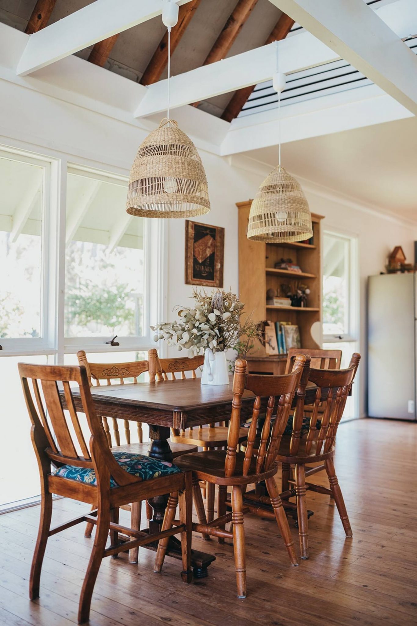 The dining room is a wooden house of white beams
