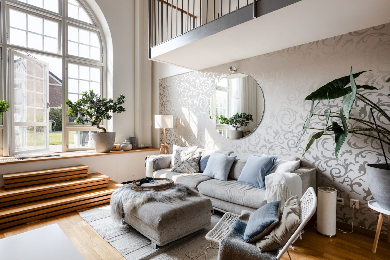 salon avec fenêtre cintrée et mezzanine appartement en duplex