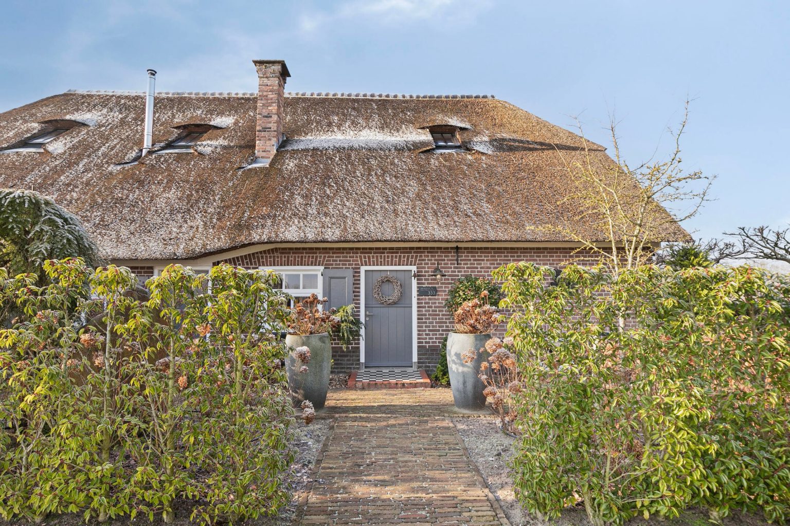 ancienne ferme rénovée en briques et toit de chaume