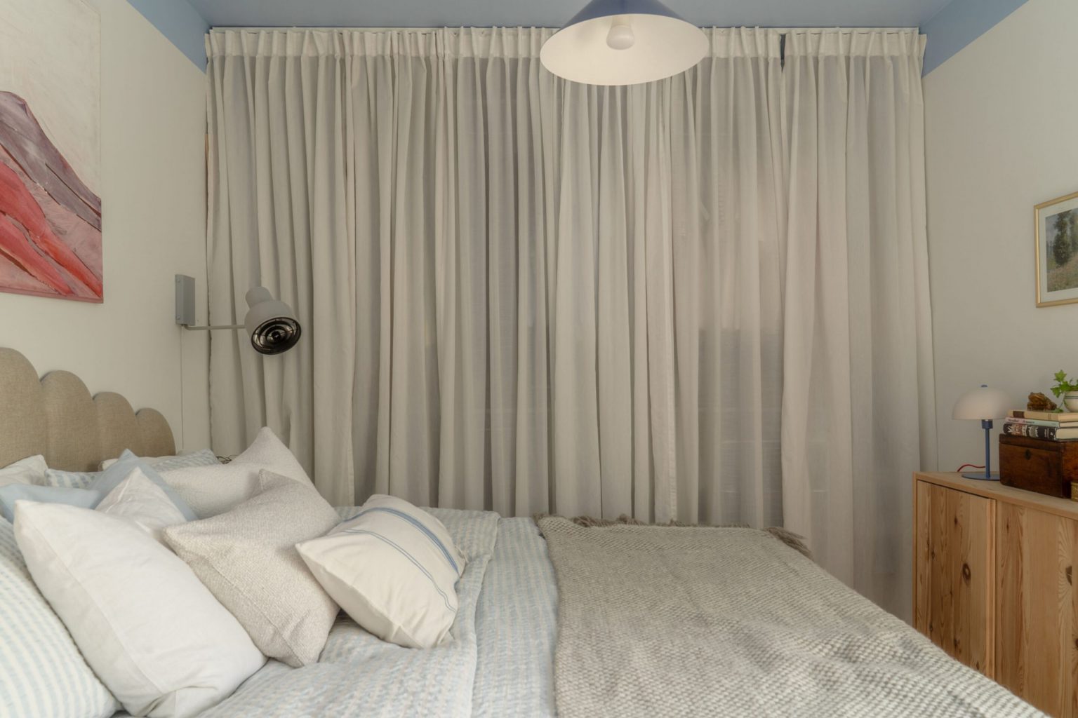 chambre avec dressing derrière un rideau murs blancs et plafond bleu