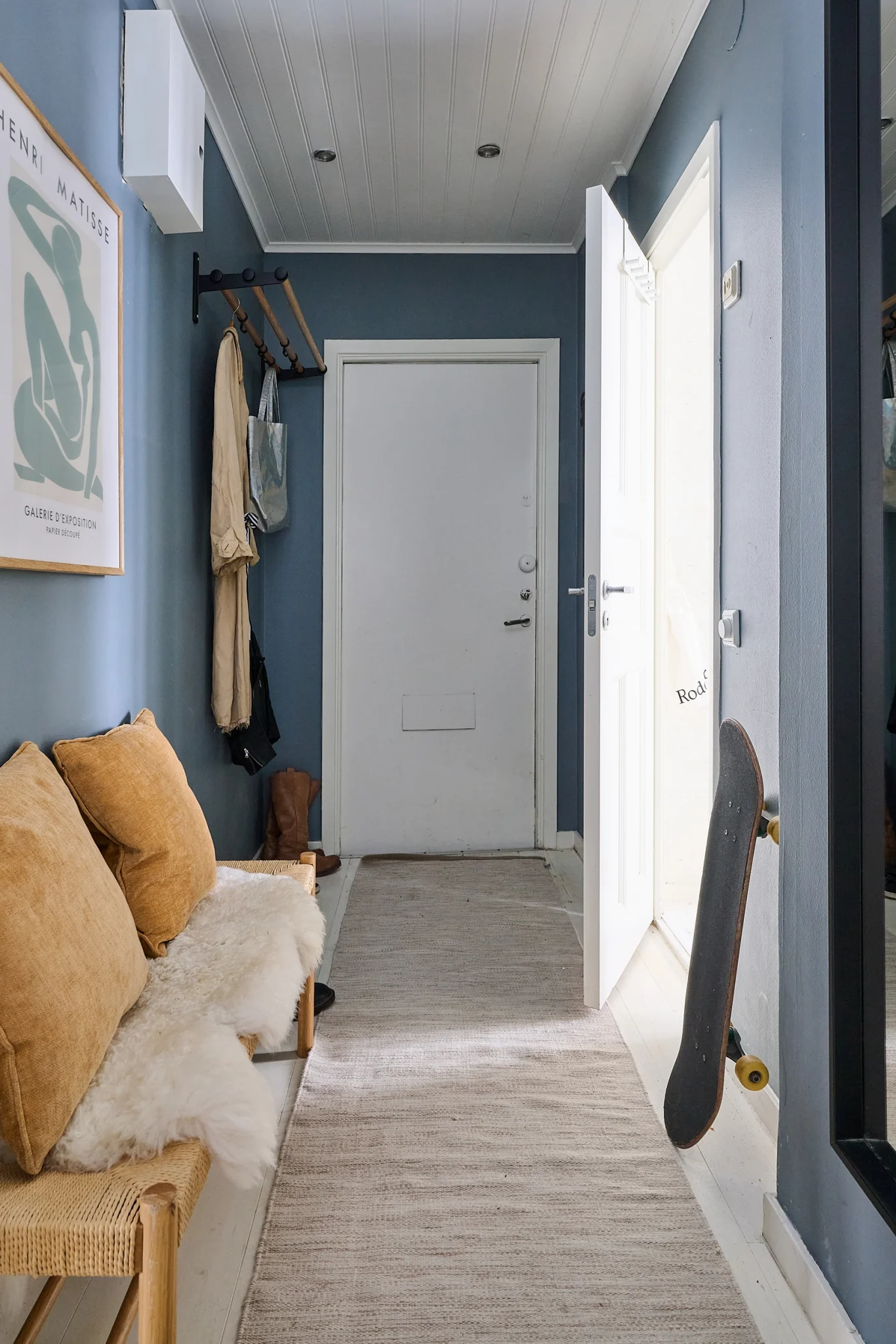 entrée murs bleus avec banc et porte-manteaux décoration scandinave