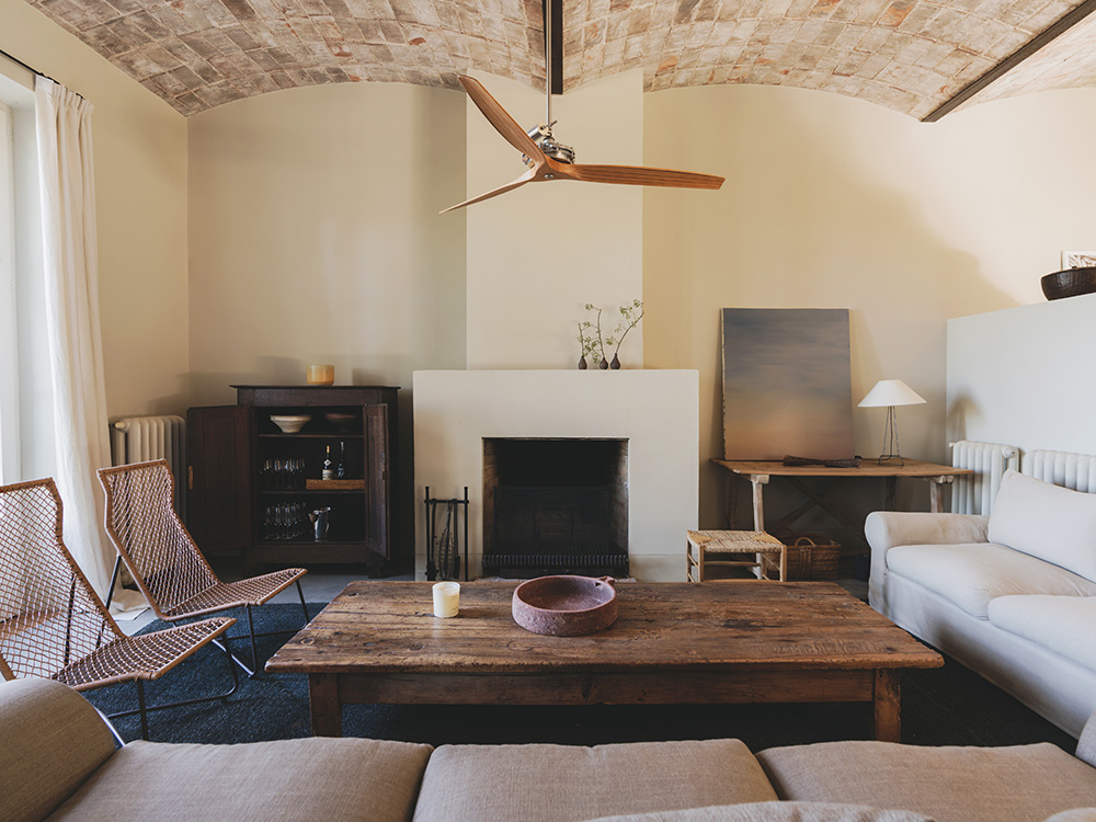 living room with fireplace rustic chic decor Mediterranean and eco-friendly house Spain Catalan ceilings