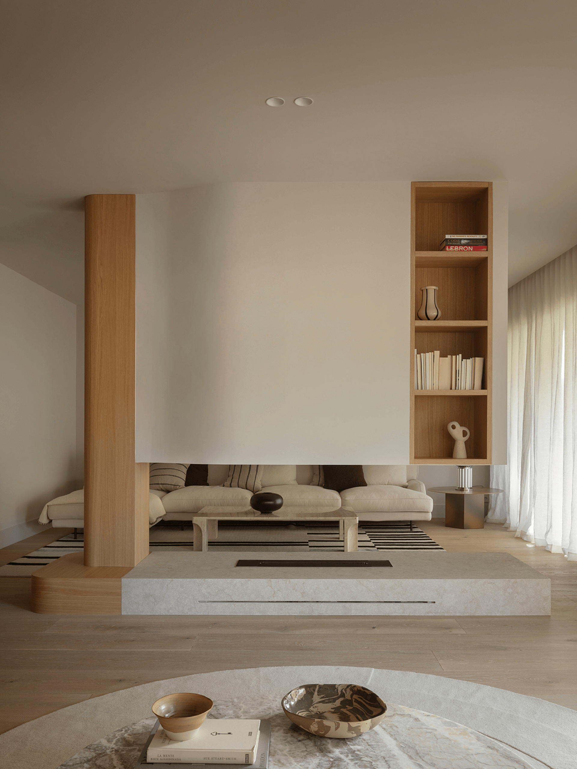 Living room with double-sided fireplace, contemporary beige decor