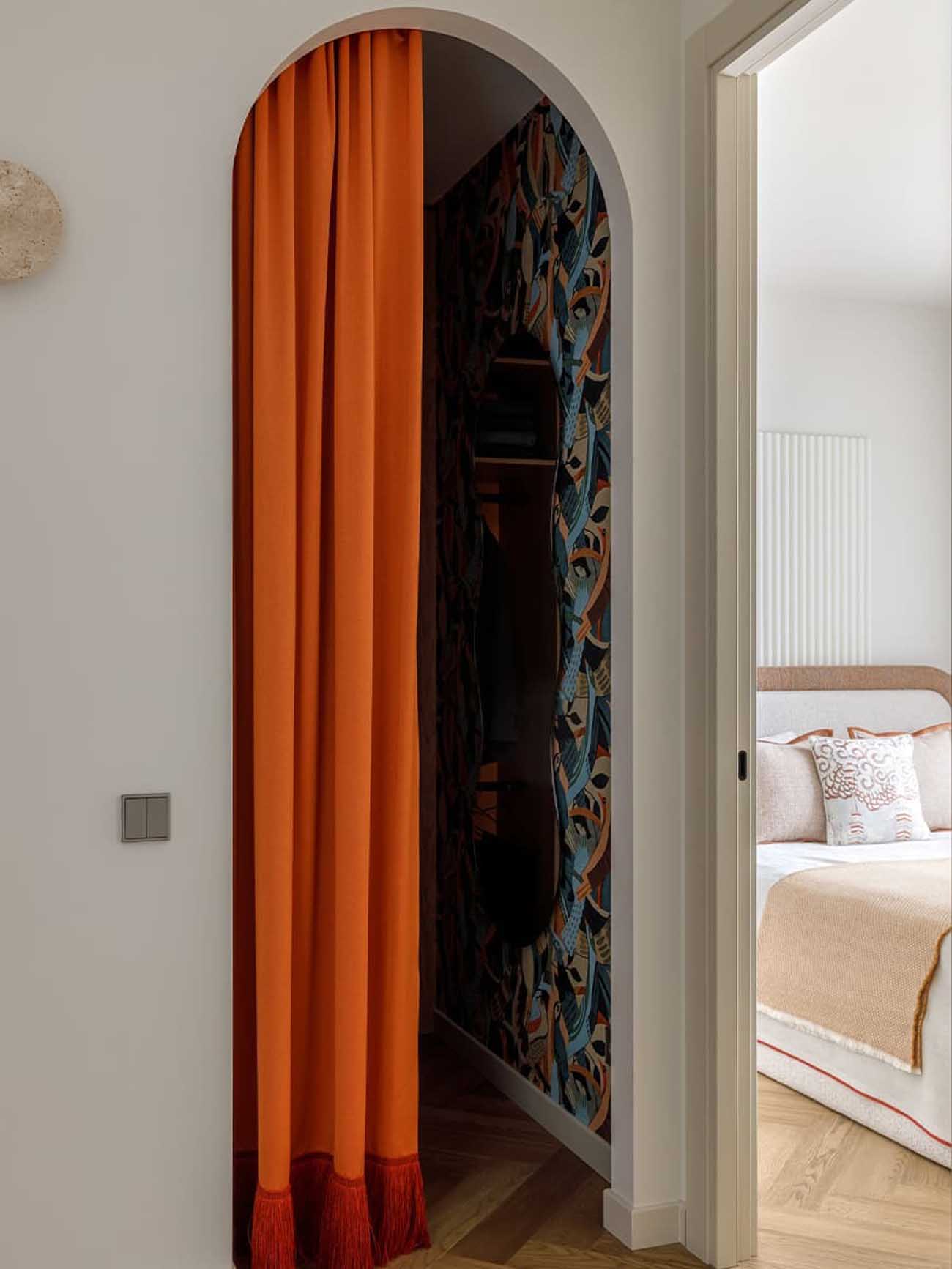 dressing room arched opening closed by orange curtain contemporary decoration two-room apartment of 37m2