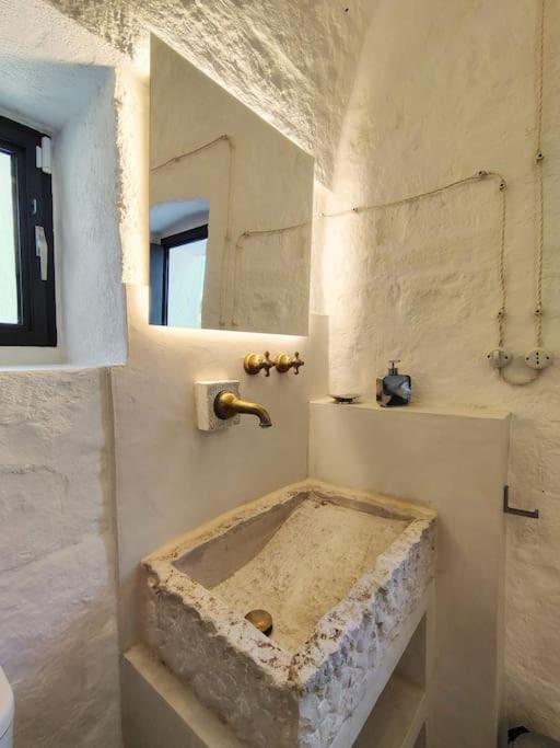 rustic bathroom with stone sink Casa Lama Monopoli