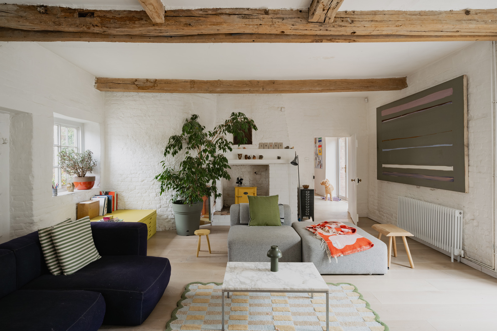 Living room with yellow stove vintage decor renovated 18th-century house in the English countryside