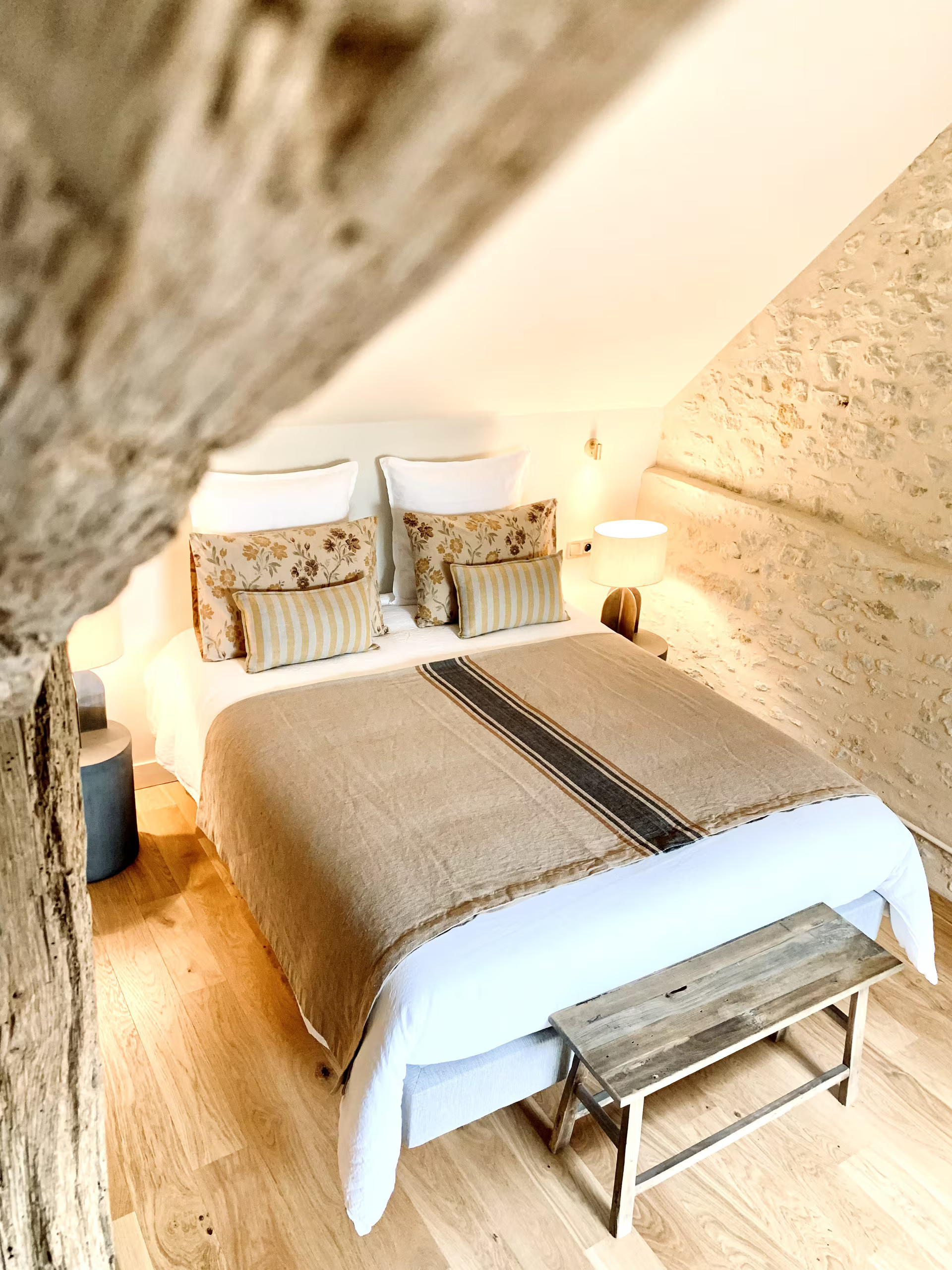 attic bedroom with beams rustic chic decor countryside France La Clef des Champs