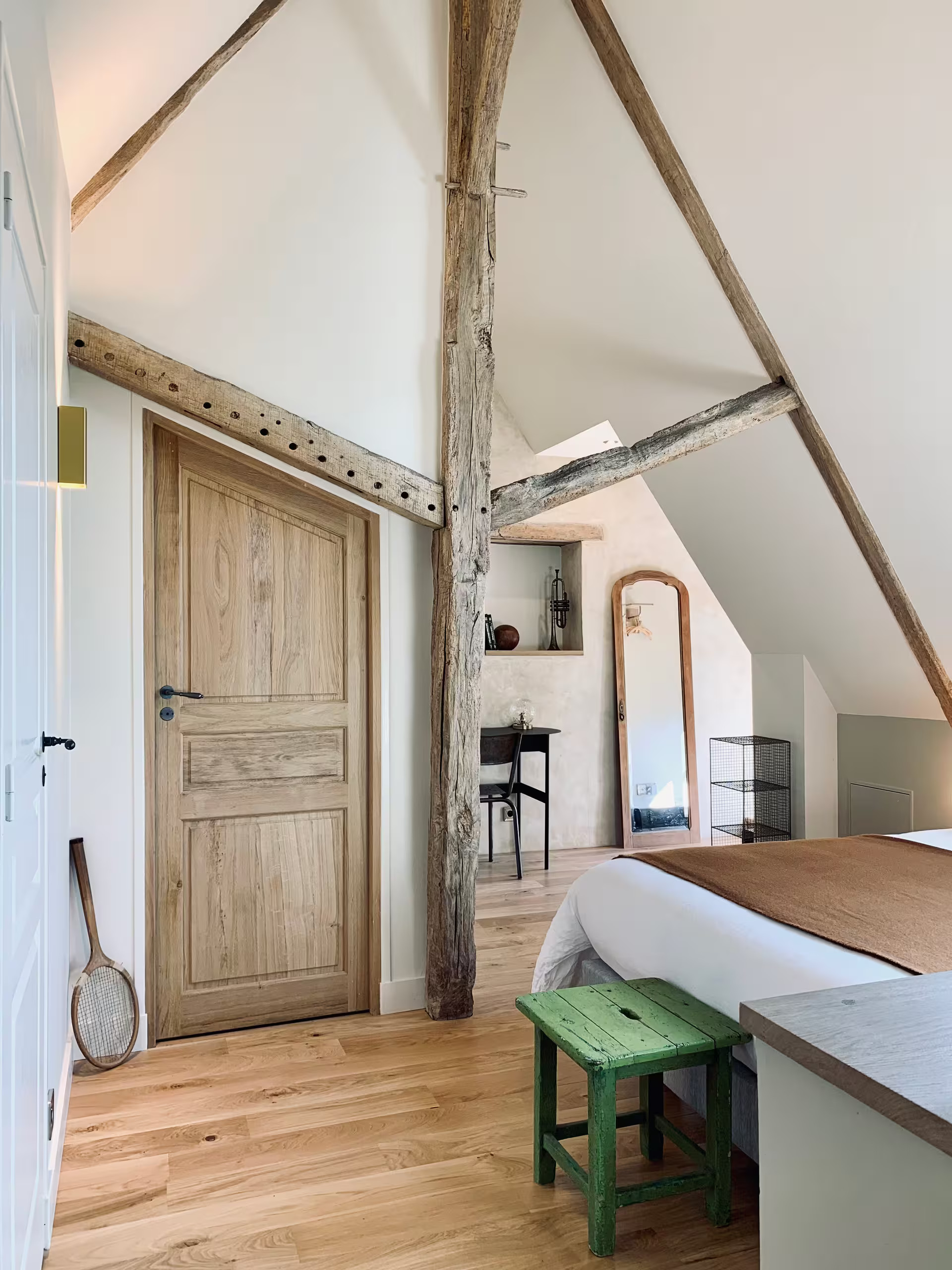 attic bedroom with beams rustic chic decor countryside France La Clef des Champs