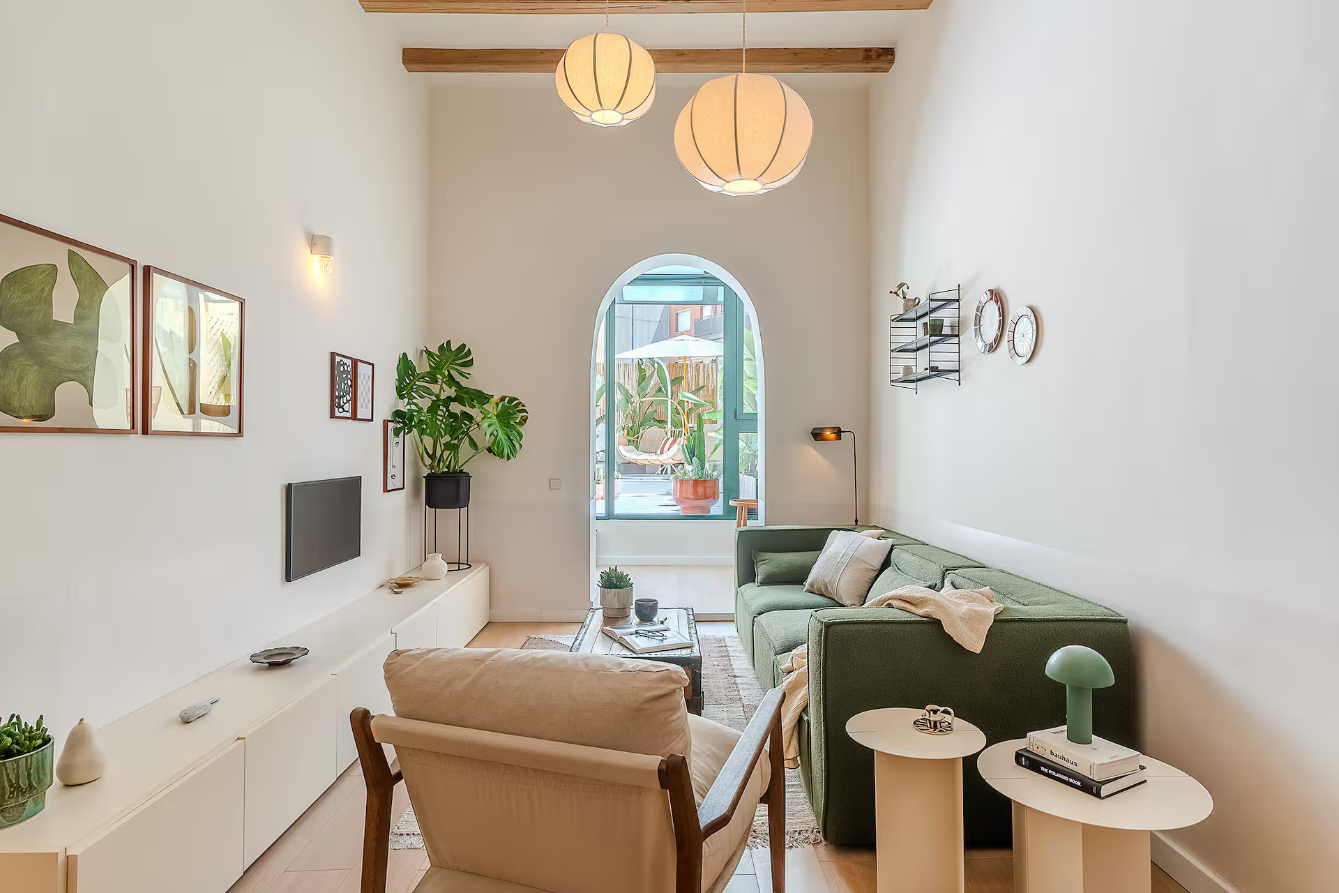 living room with green sofa modern apartment in Barcelona