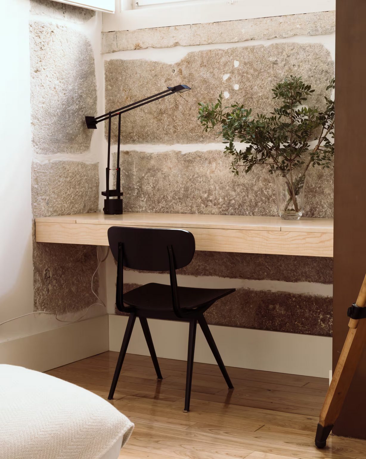 bureau dans salon avec mur de pierres