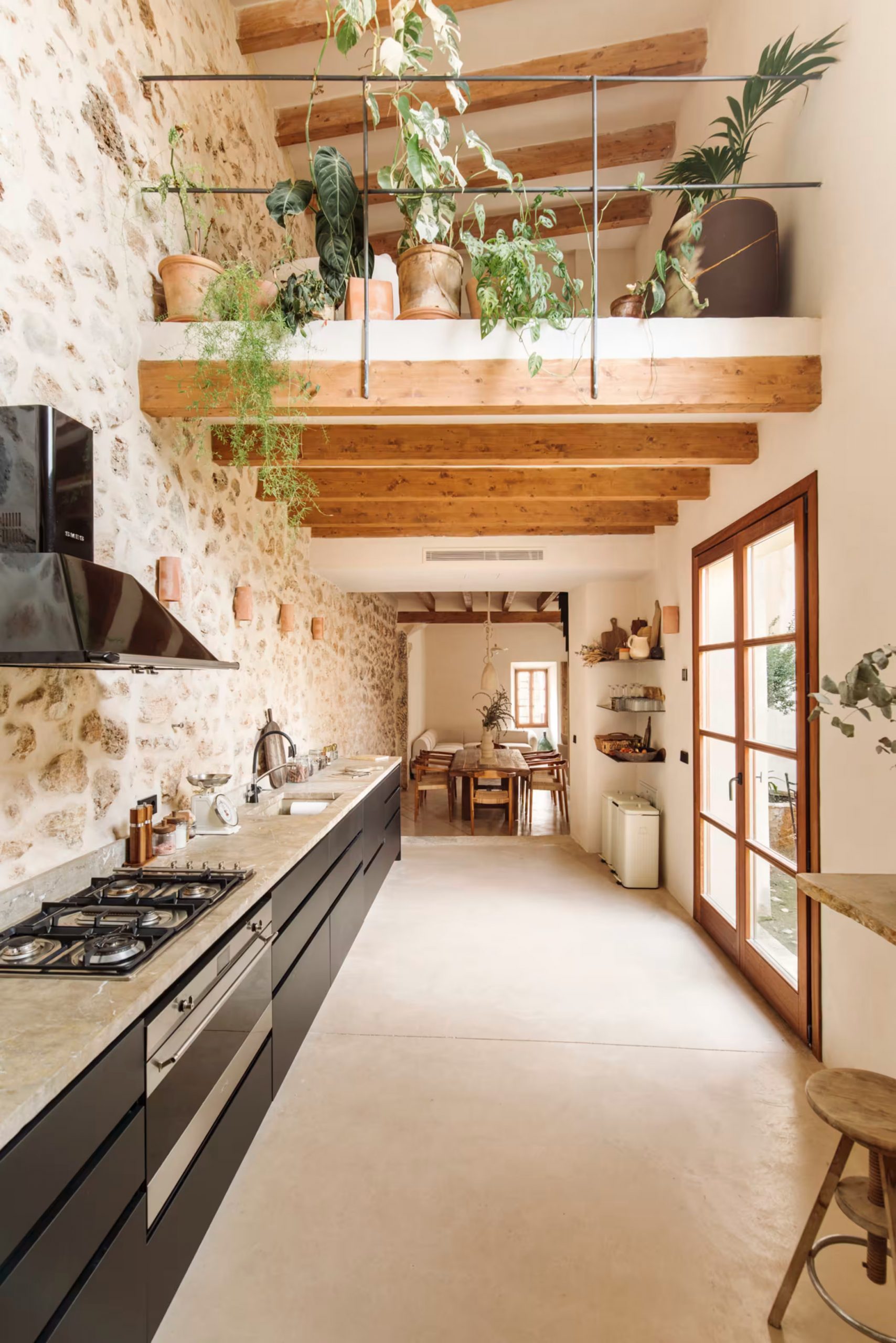 kitchen with stone wall, contemporary decor, renovated home in Mallorca