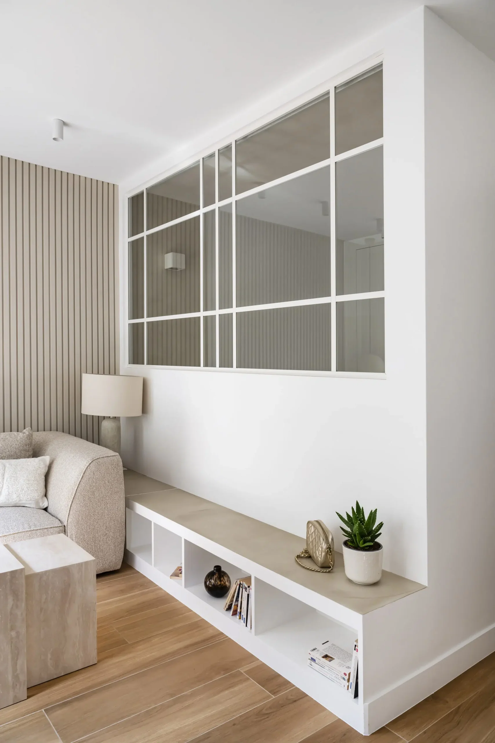 living room with glass partition 28sqm apartement contemporary decor near Paris in beige tons Photo: © Julien Pépy