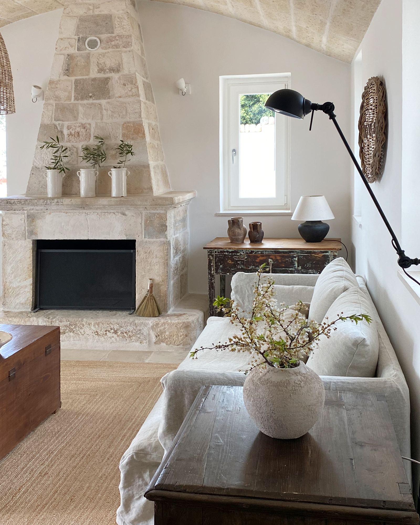  living room with stone fireplace rustic chic decor renovated trullo in Puglia Trullo Falco