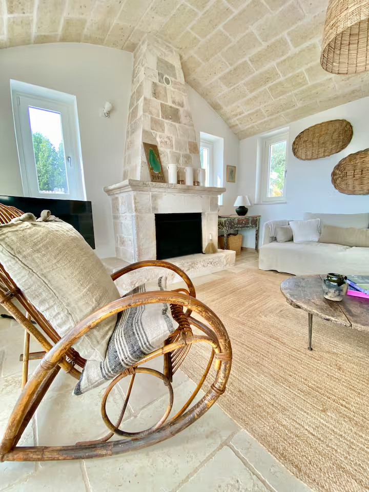 vaulted living room with stone fireplace rustic chic decor renovated trullo in Puglia Trullo Falco