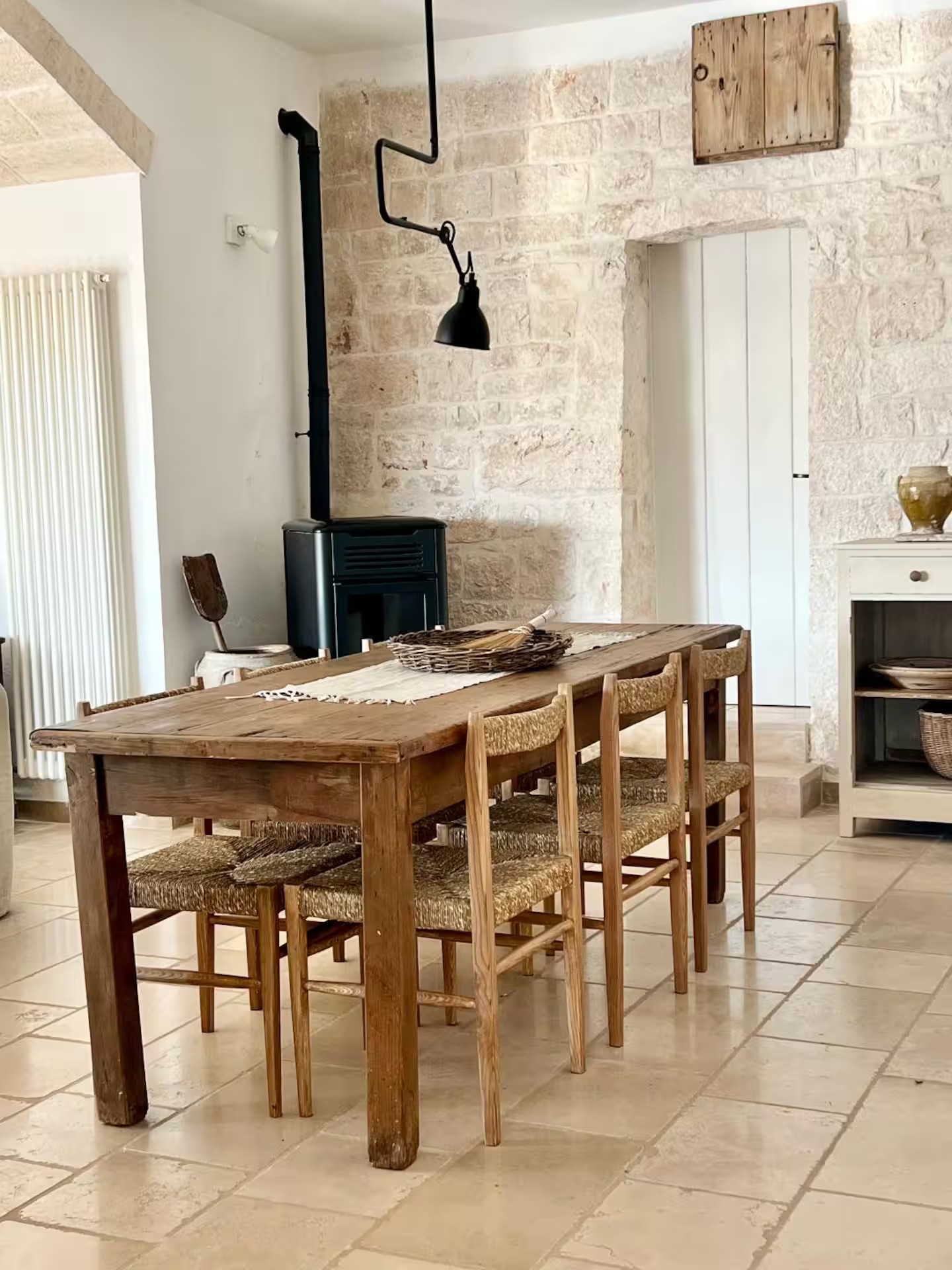 dining room with stove and stone walls rustic chic decor renovated trullo in Puglia Trullo Falco