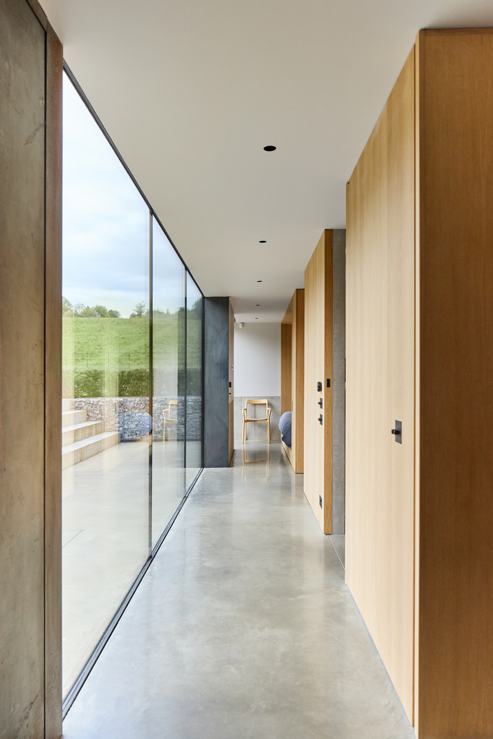 hallway with bay window and concrete floor architect house
