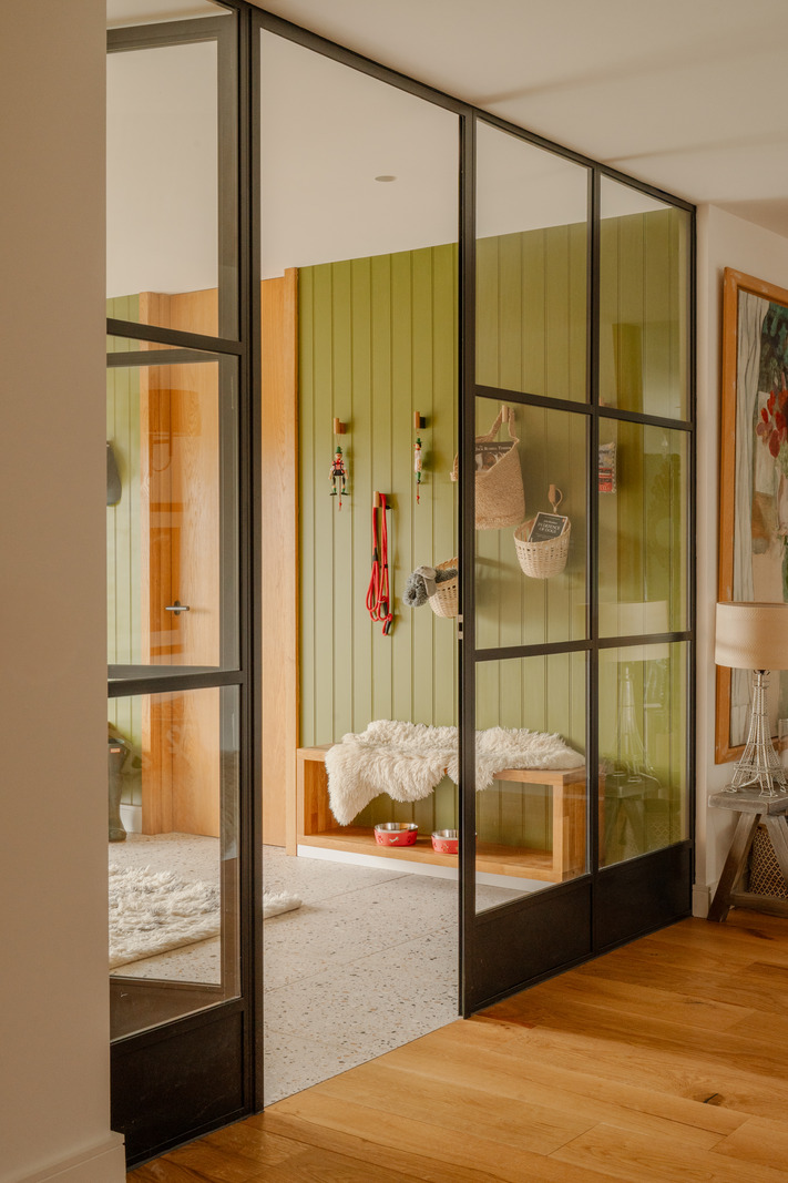 hallway with green wall and glazed partition