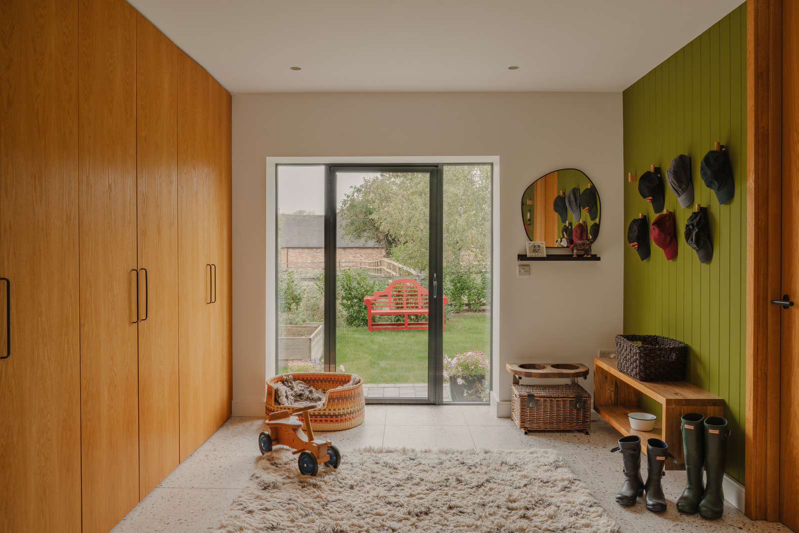 hallway with wooden cupboards and green wall