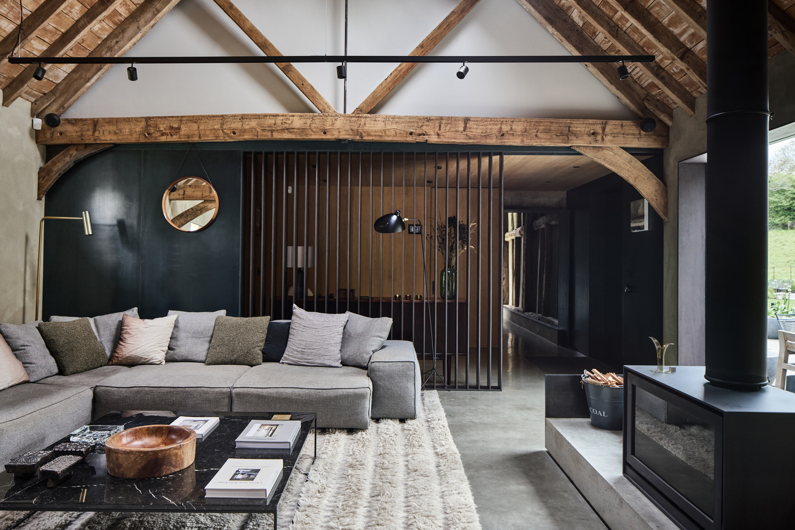 living room with beams and stove contemporary decor former English barn renovated concrete floor
