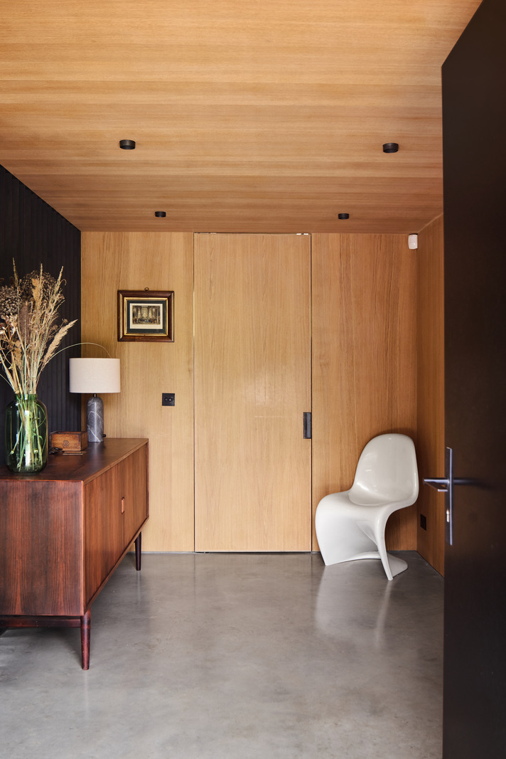 entryway with wooden walls