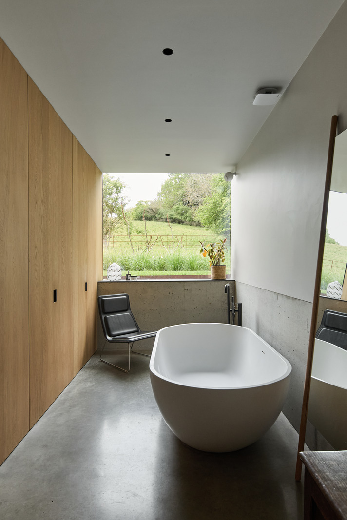 designer bathroom with island bathtub and picture window