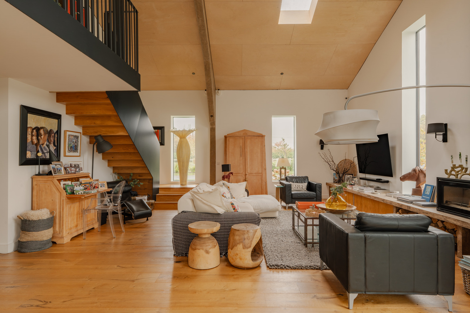 double height living room contemporary decor with mezzanine and stove