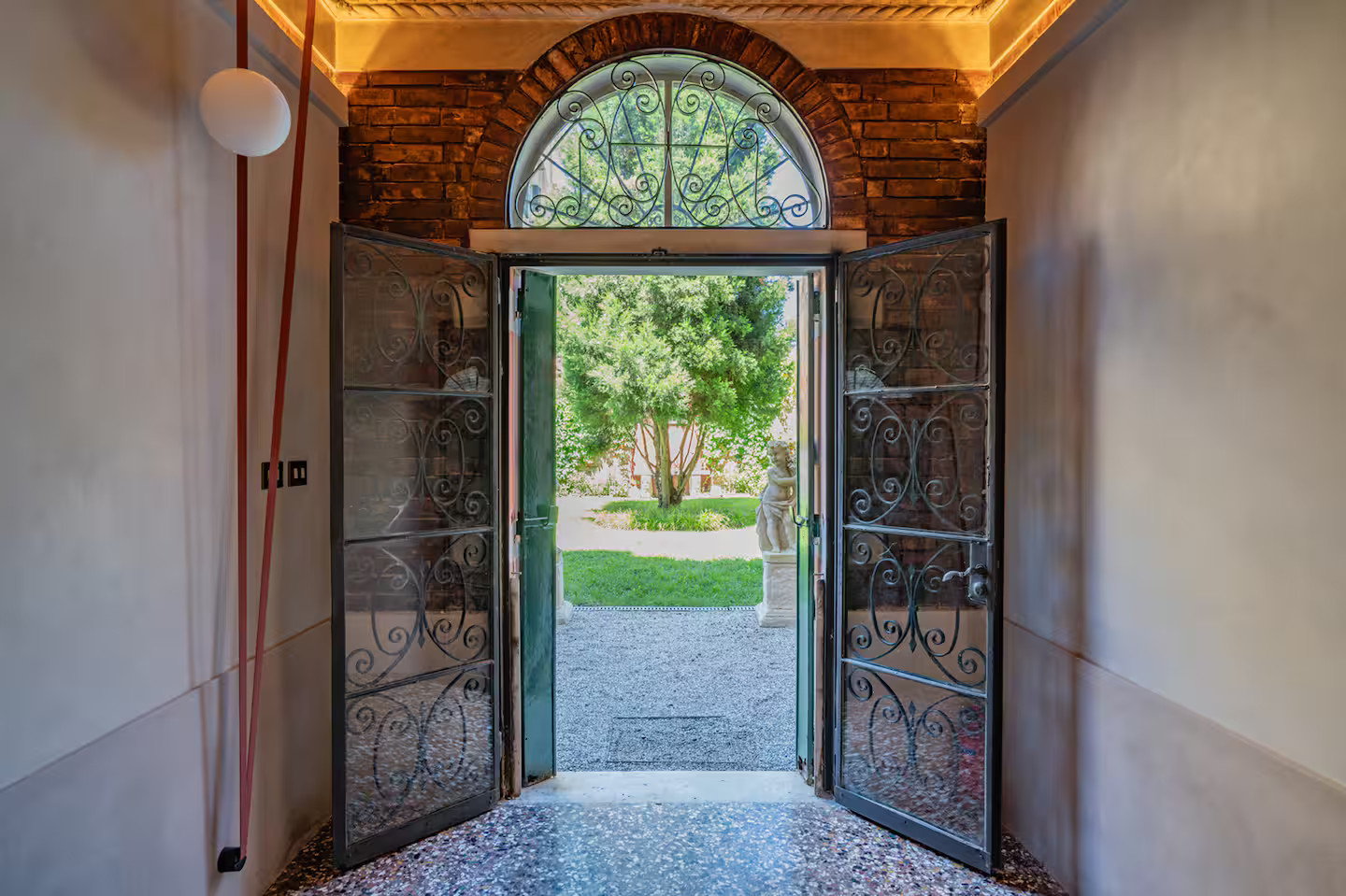 entryway with period terrazzo and arched door Casa della Sensa entryway with period terrazzo and arched door Casa della Sensa