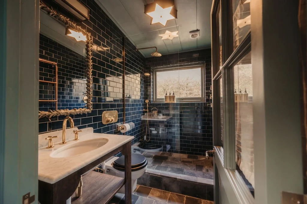 green tiled bathroom small house UKAI by HÁM Interiors