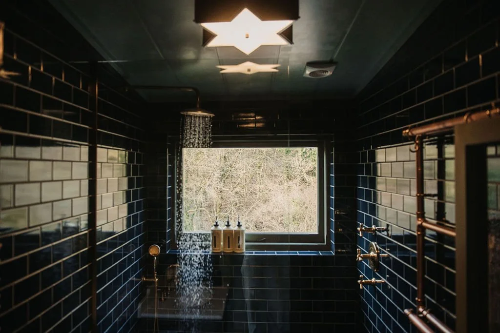 green tiled bathroom small house UKAI by HÁM Interiors
