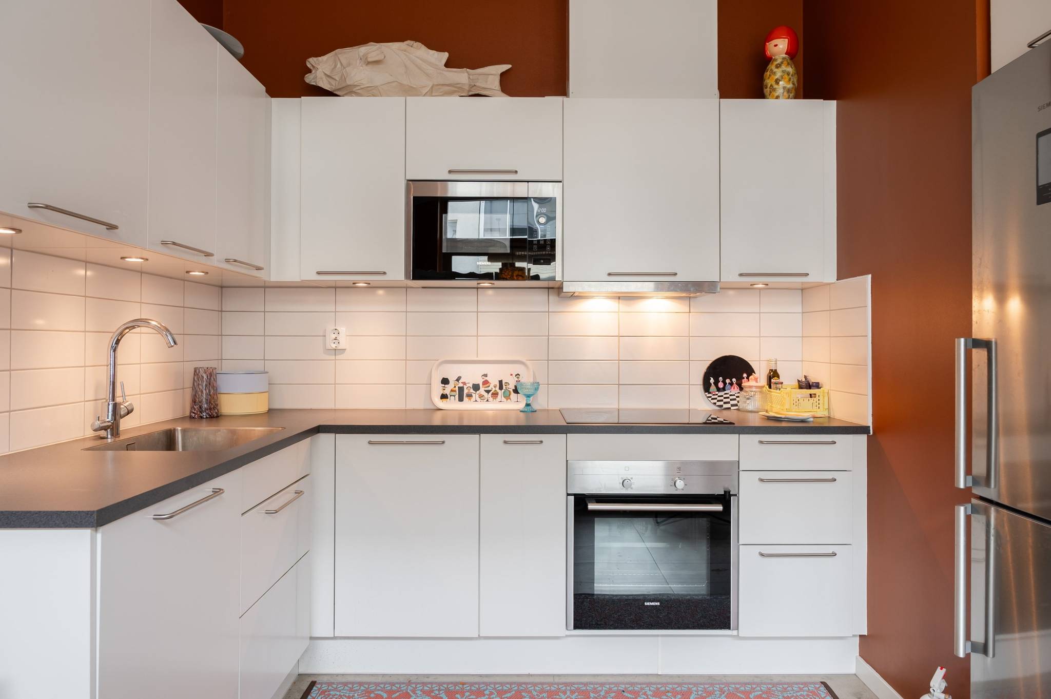 white open kitchen terracotta walls
