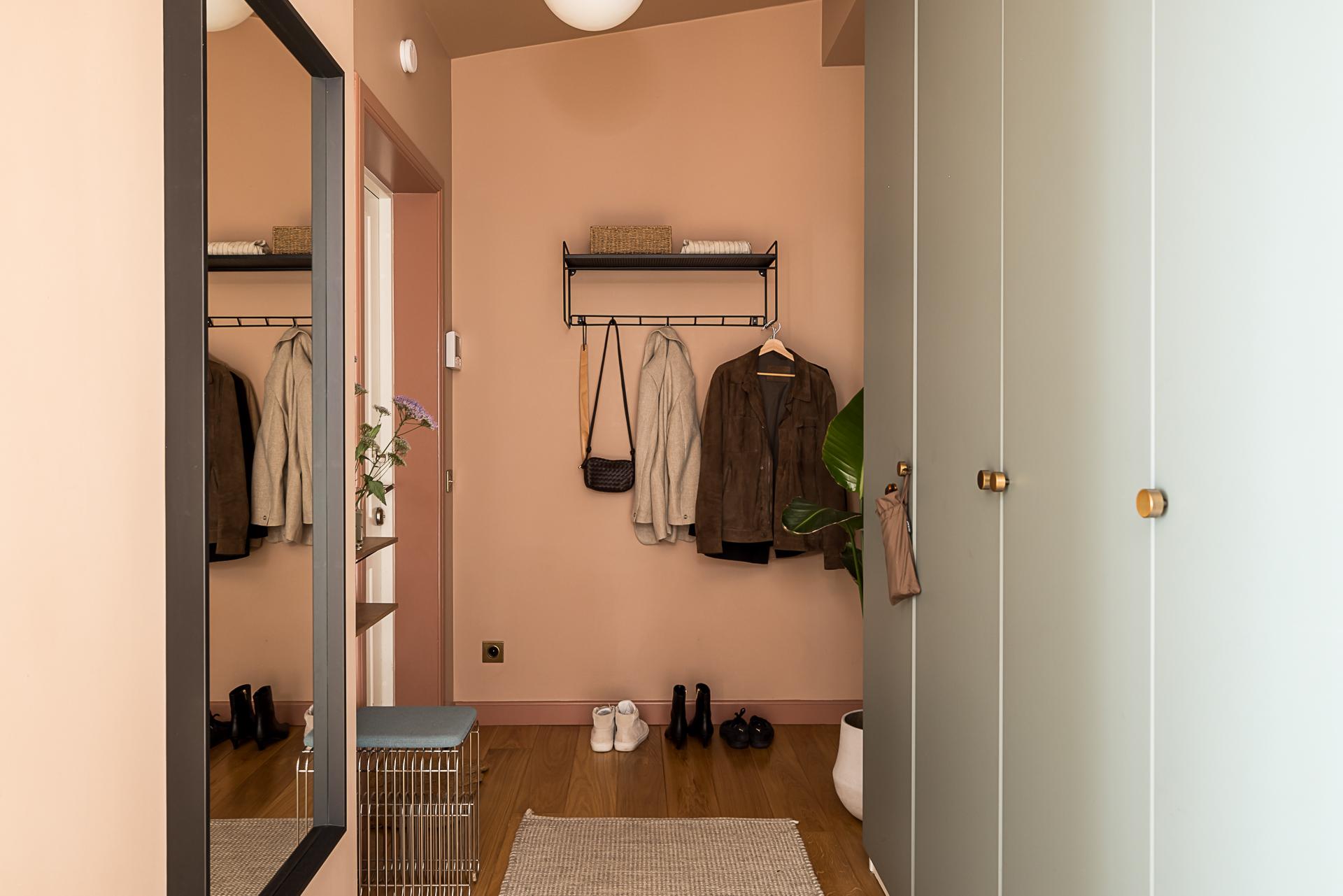 pink entryway with cupboards