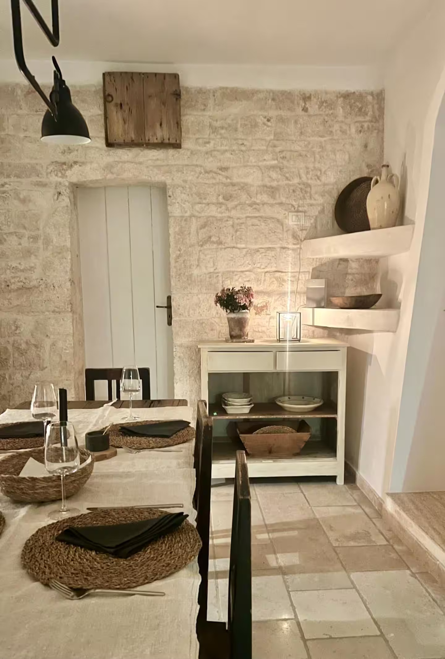 dining room with stone walls rustic chic decor renovated trullo in Puglia Trullo Falco