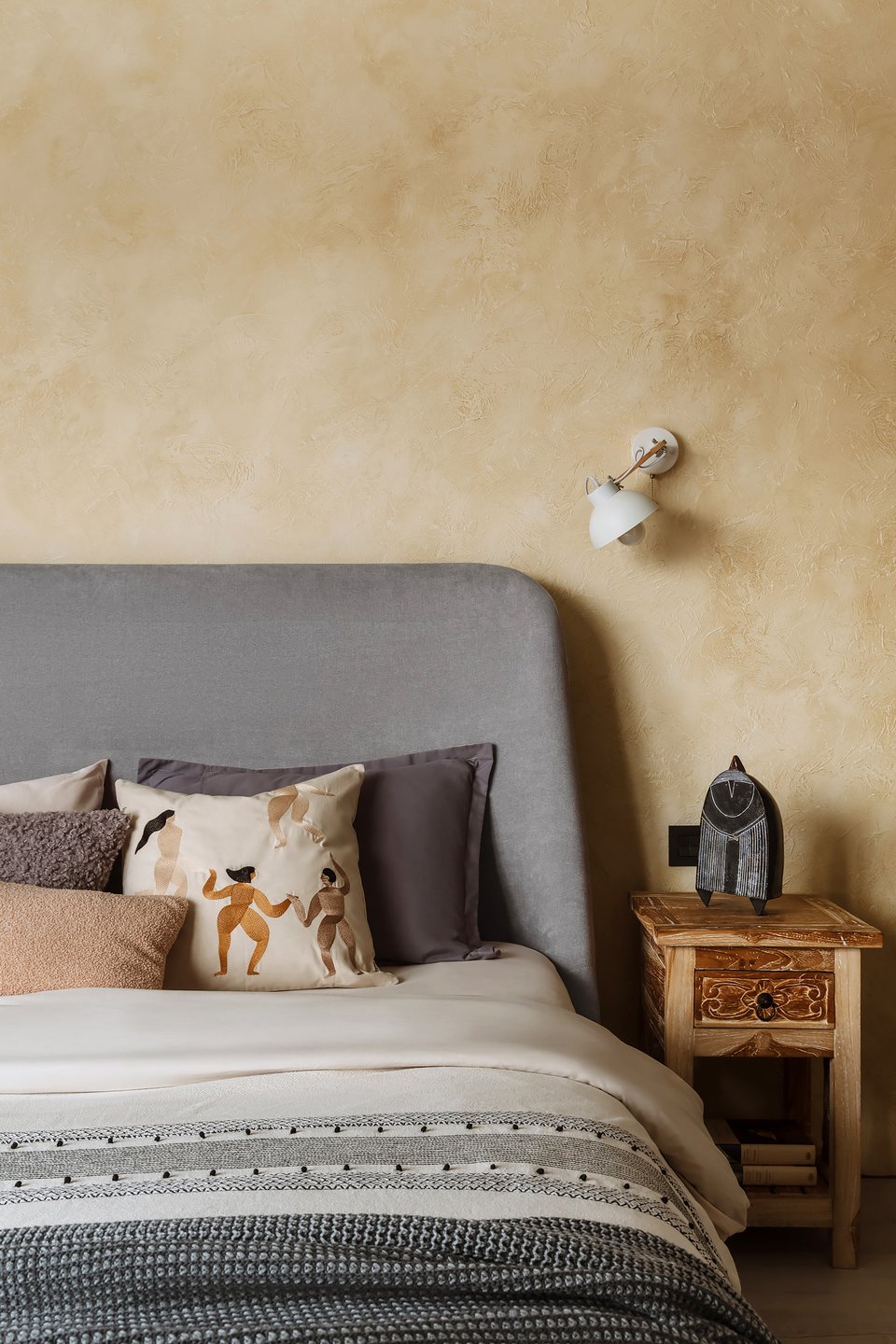 modern ethnic bedroom with yellow plastered wall