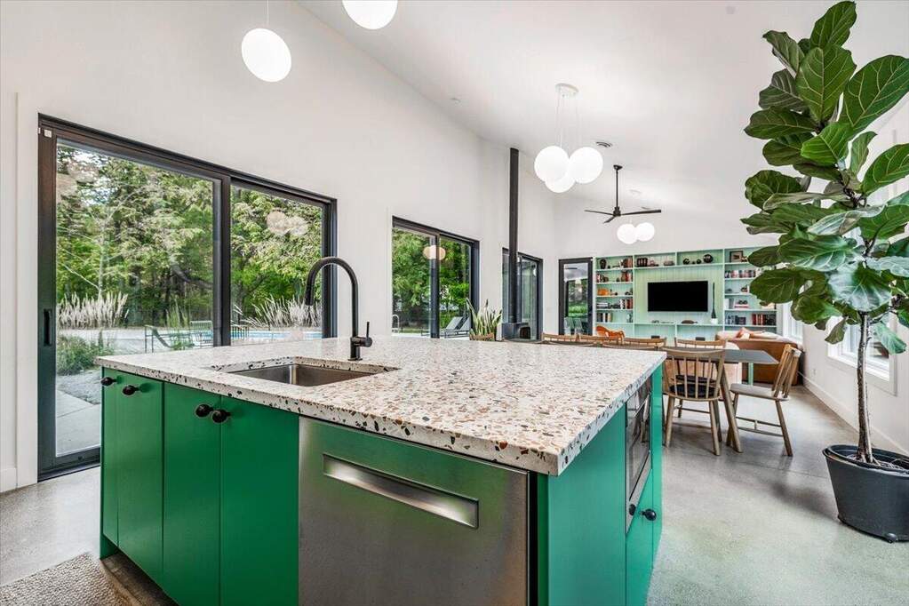 salon avec cuisine ouverte verte et terrazzo gris décoration contemporaine et vintage maison d'architecte avec piscine Lac Michigan