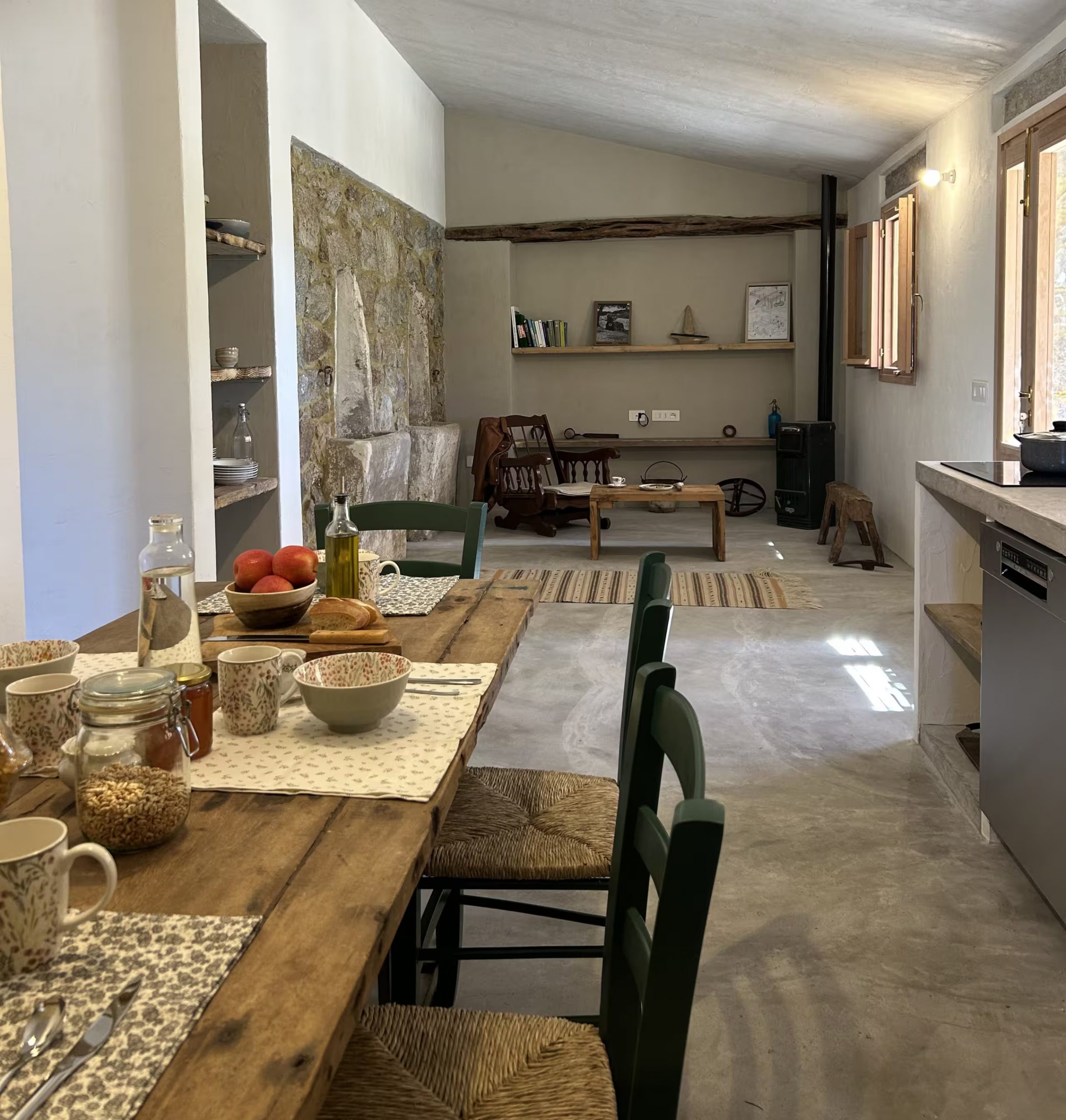 open kitchen dining room and living room with rustic and authentic decor in a historic Sardinian house