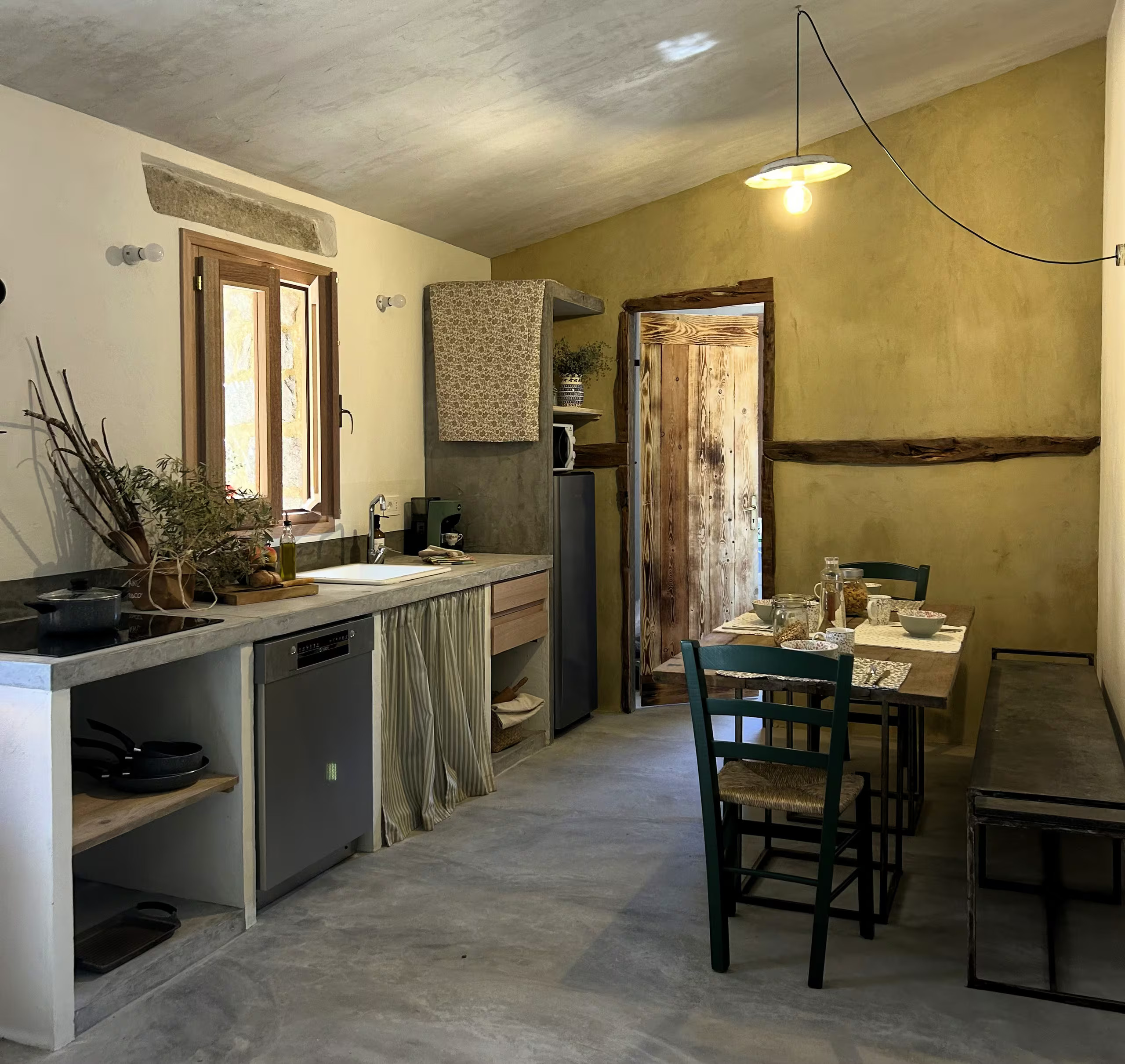 open kitchen dining room with rustic and authentic decor in a historic Sardinian house