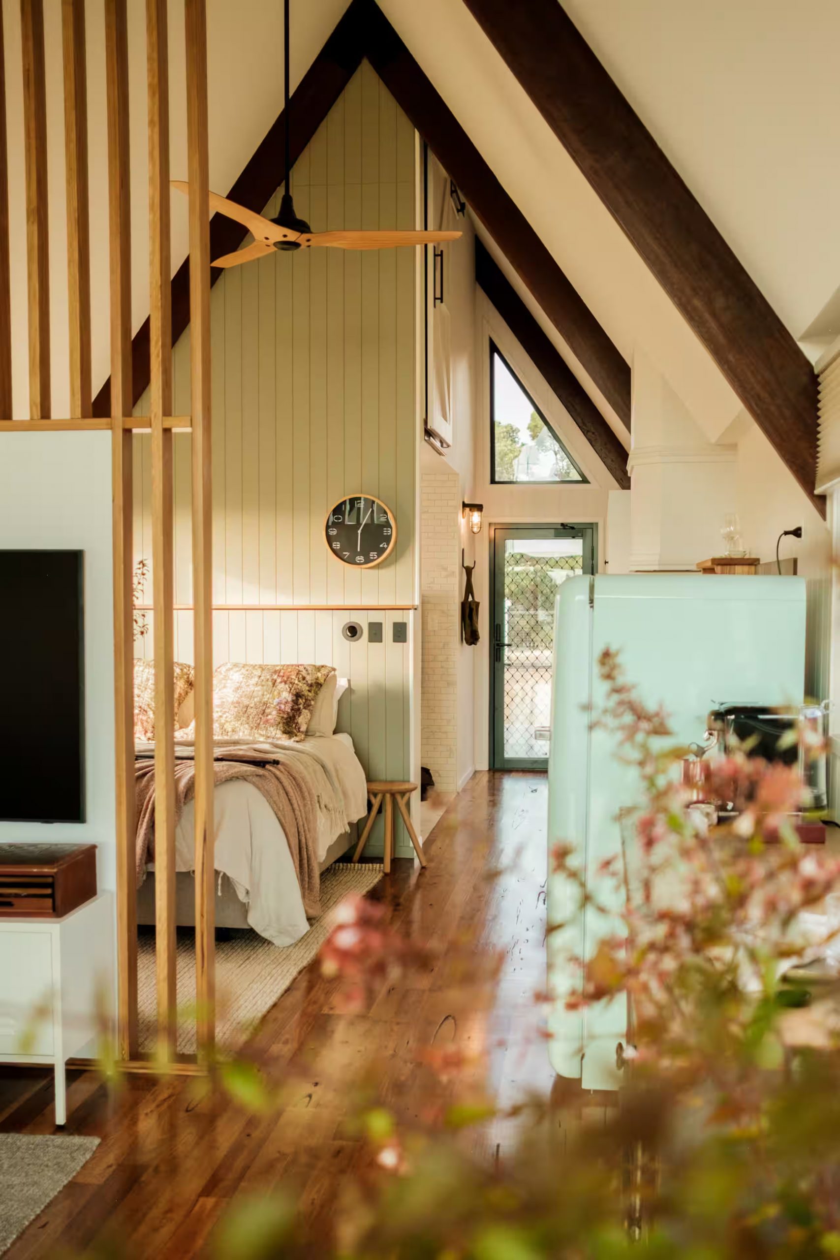 bedroom and living room off-grid wooden A-Frame house in Tasmania bedroom and living room off-grid wooden A-Frame house in Tasmania