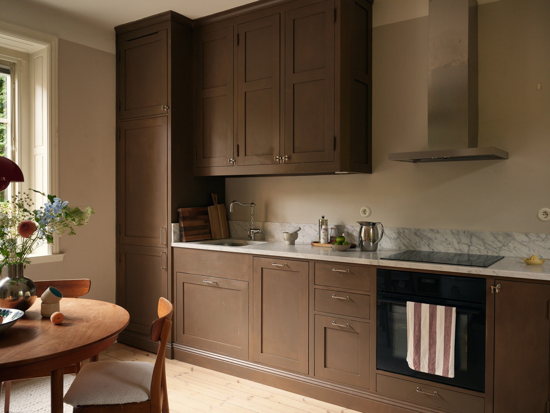 brown shaker kitchen with dining room in a 58sqm apartment Scandinavian decor