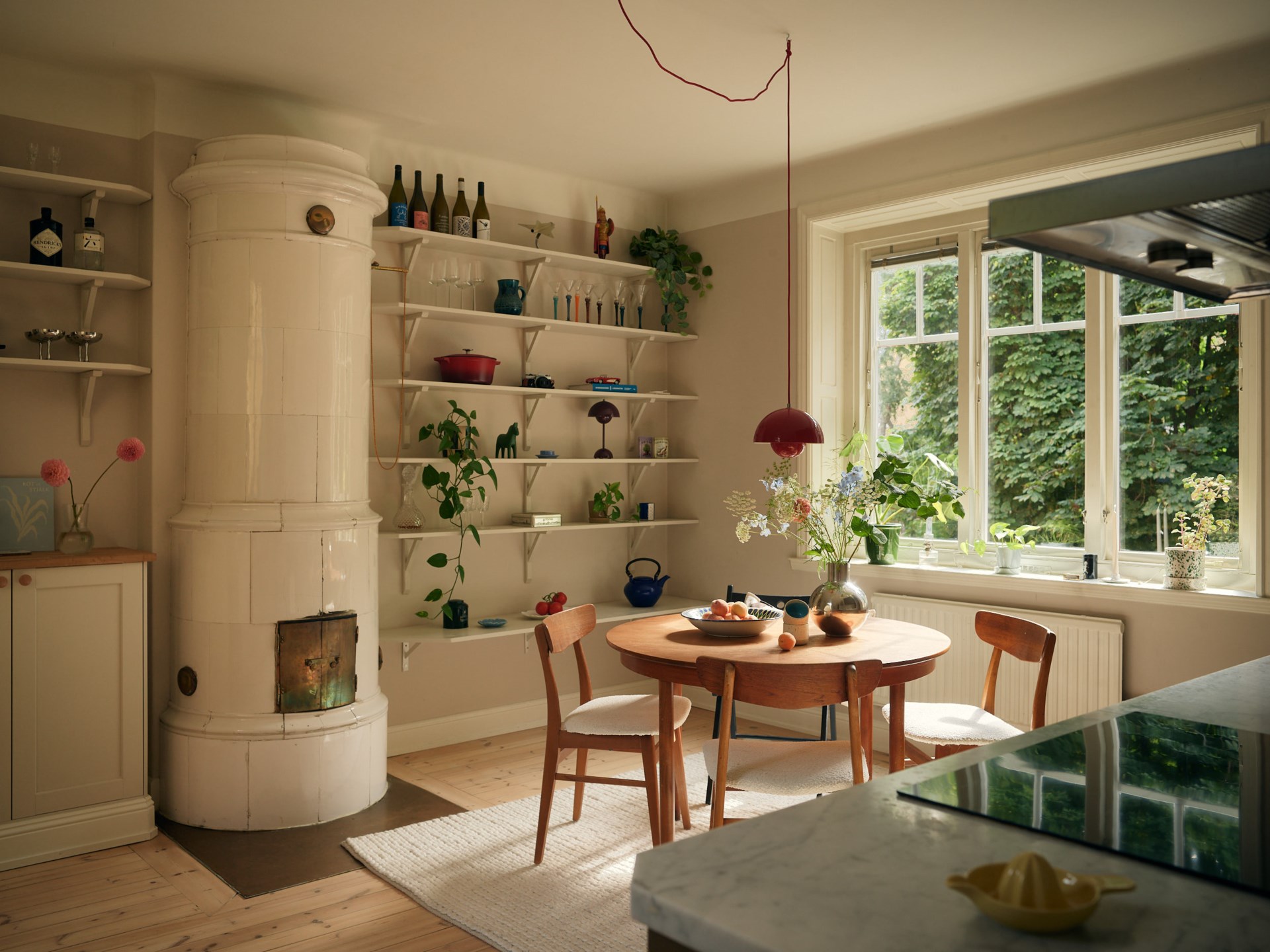 brown shaker kitchen with dining room and historic stove in a 58sqm apartment Scandinavian decor