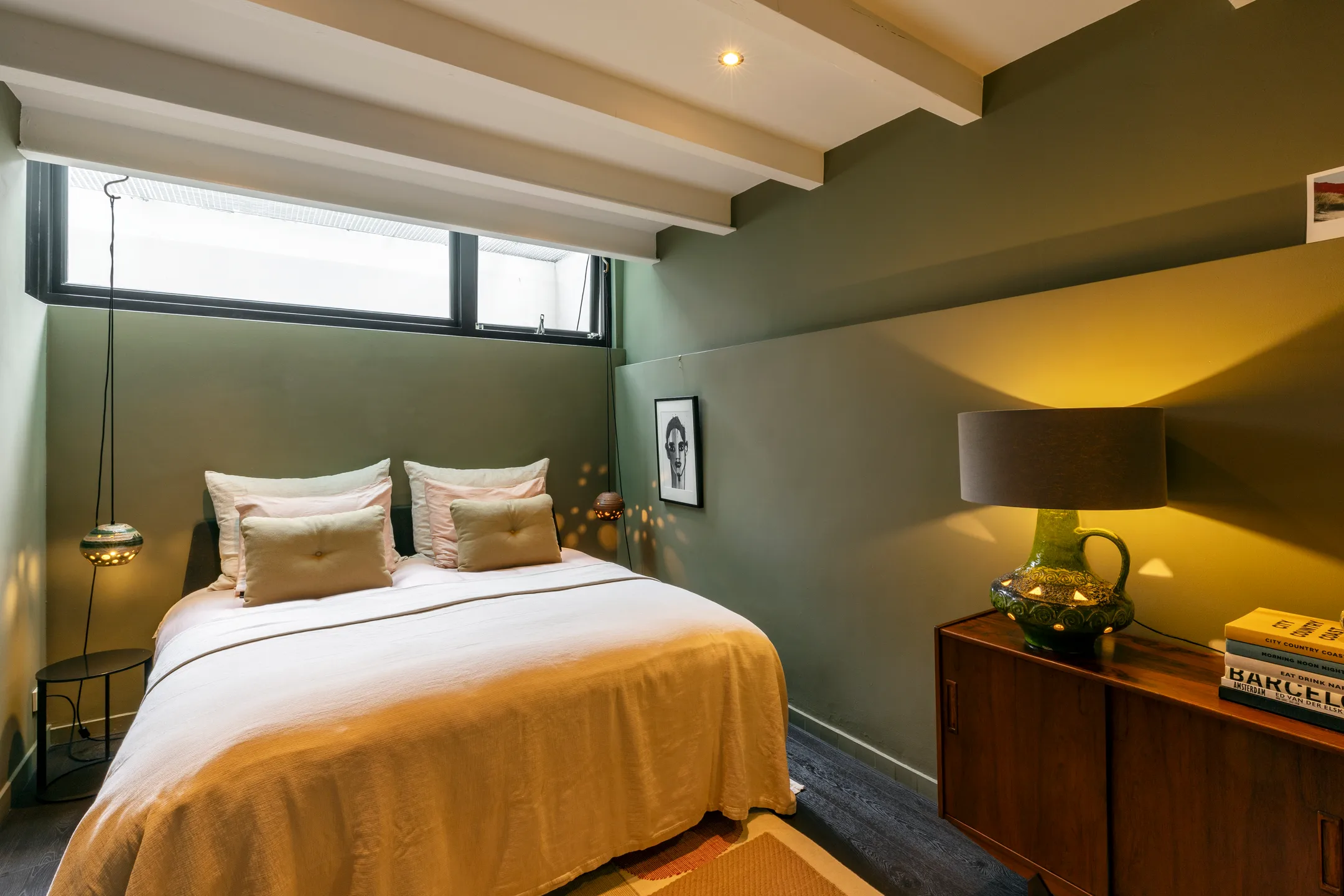 bedroom with green walls in the basement 191sqm duplex apartment contemporary decor Amsterdam