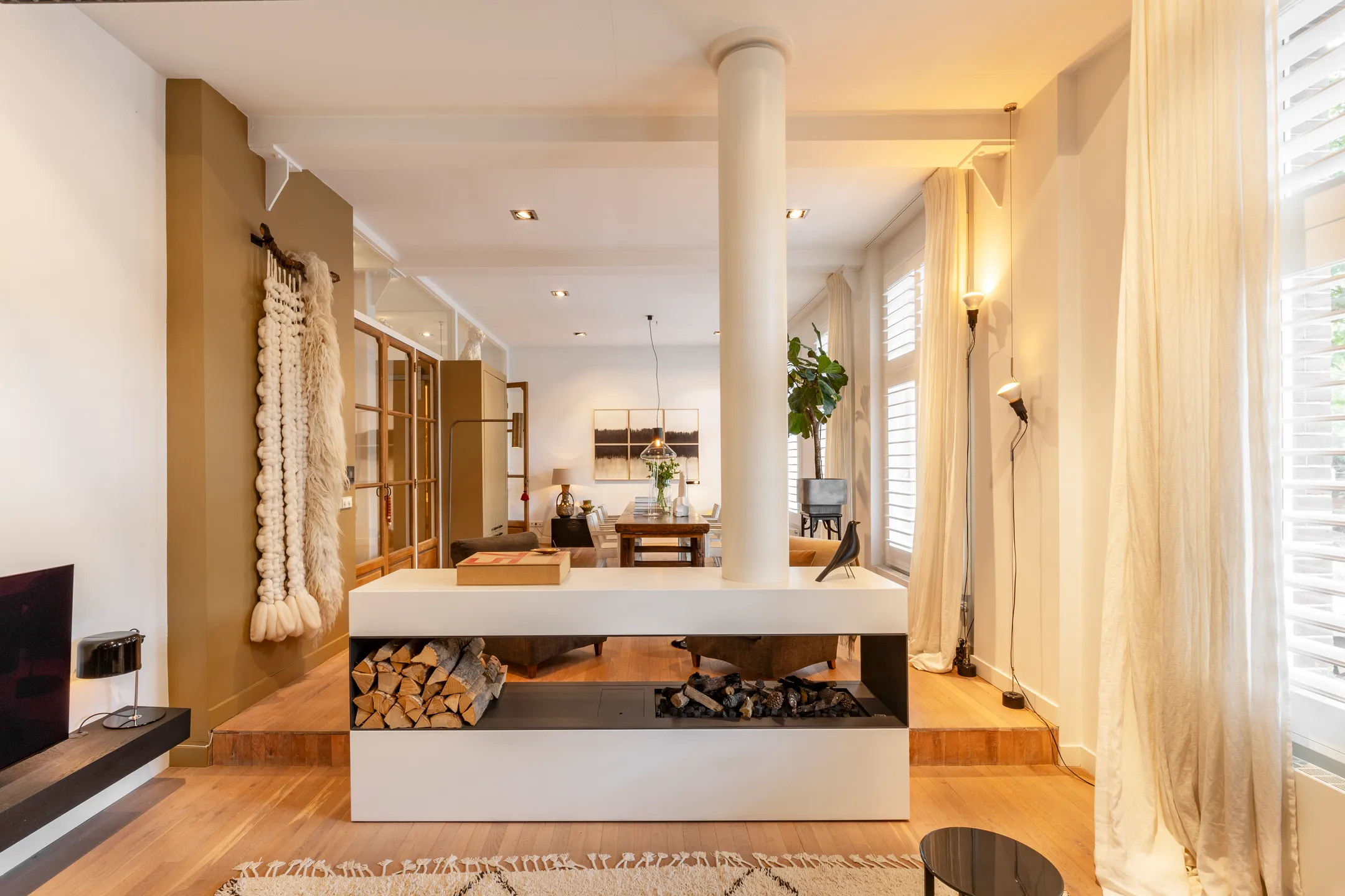living room with designer fireplace 191sqm duplex apartment contemporary decor Amsterdam