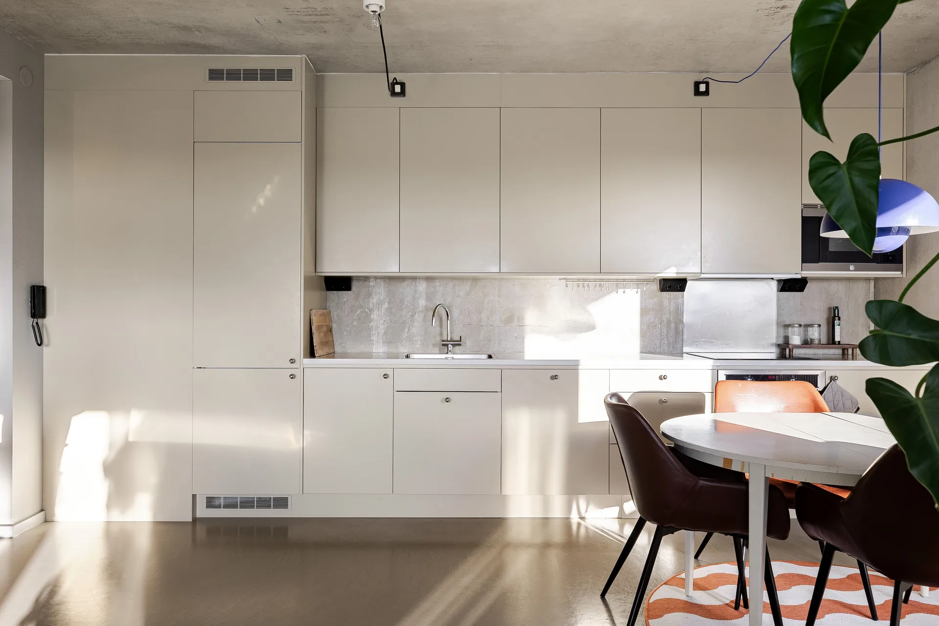 open white kitchen dining room with concrete floor walls and ceiling 48sqm two-room apartment Scandinavian decor