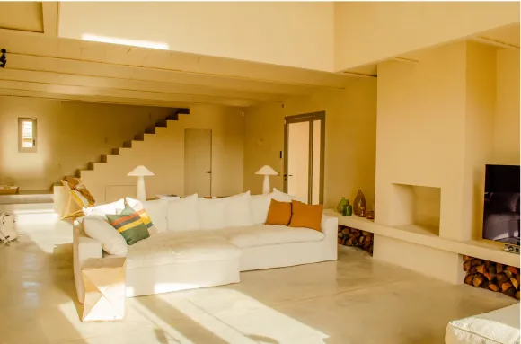 double height living room with fireplace Casa Carolina house in Emporda Spain with pool rustic chic decor