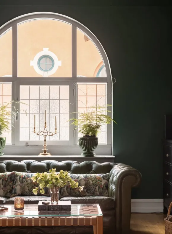 living room with moss-green walls and ceiling 1909 duplex apartment in Malmö classic chic and scandinavian decor