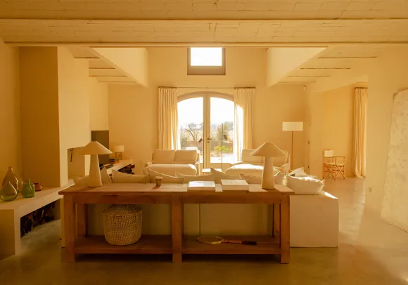 double height living room with fireplace Casa Carolina house in Emporda Spain with pool rustic chic decor