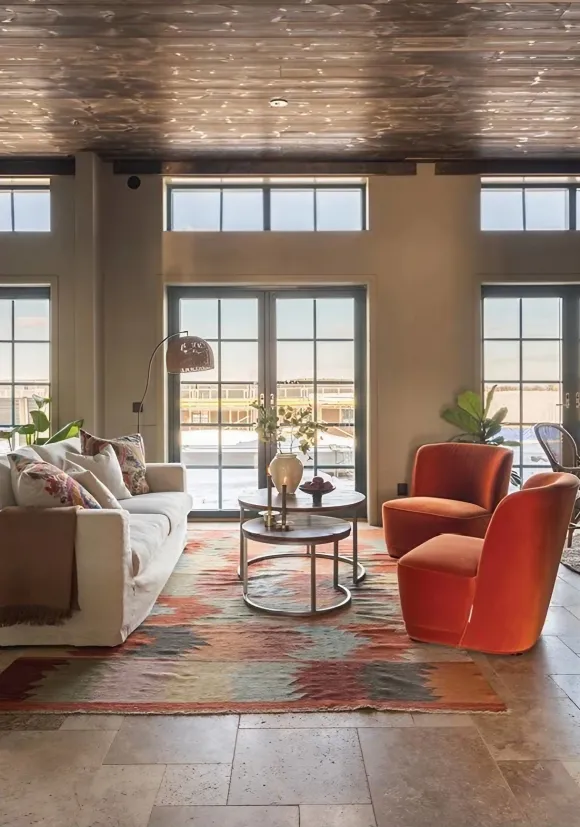 living room with orange velvet armchairs open kitchen 81sqm contemporary duplex with a homey feel