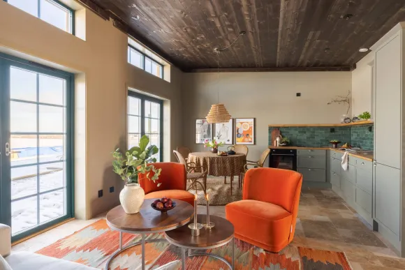 living room with orange velvet armchairs open kitchen 81sqm contemporary duplex with a homey feel